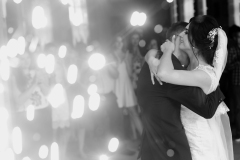 happy gorgeous wedding couple having first dance at wedding party in restaurant reception with fireworks. romantic moment of emotional bride and stylish groom dancing. space for text